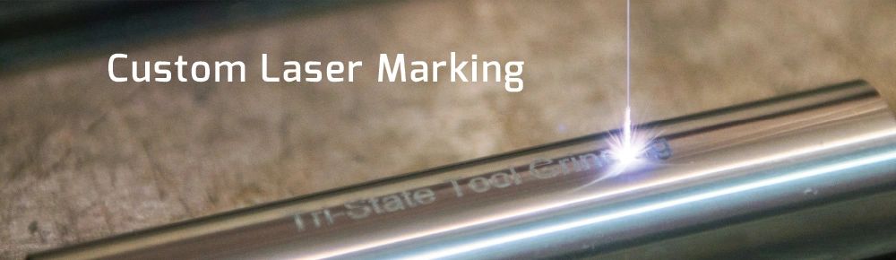 A close up of the word laser marking on a metal pipe.