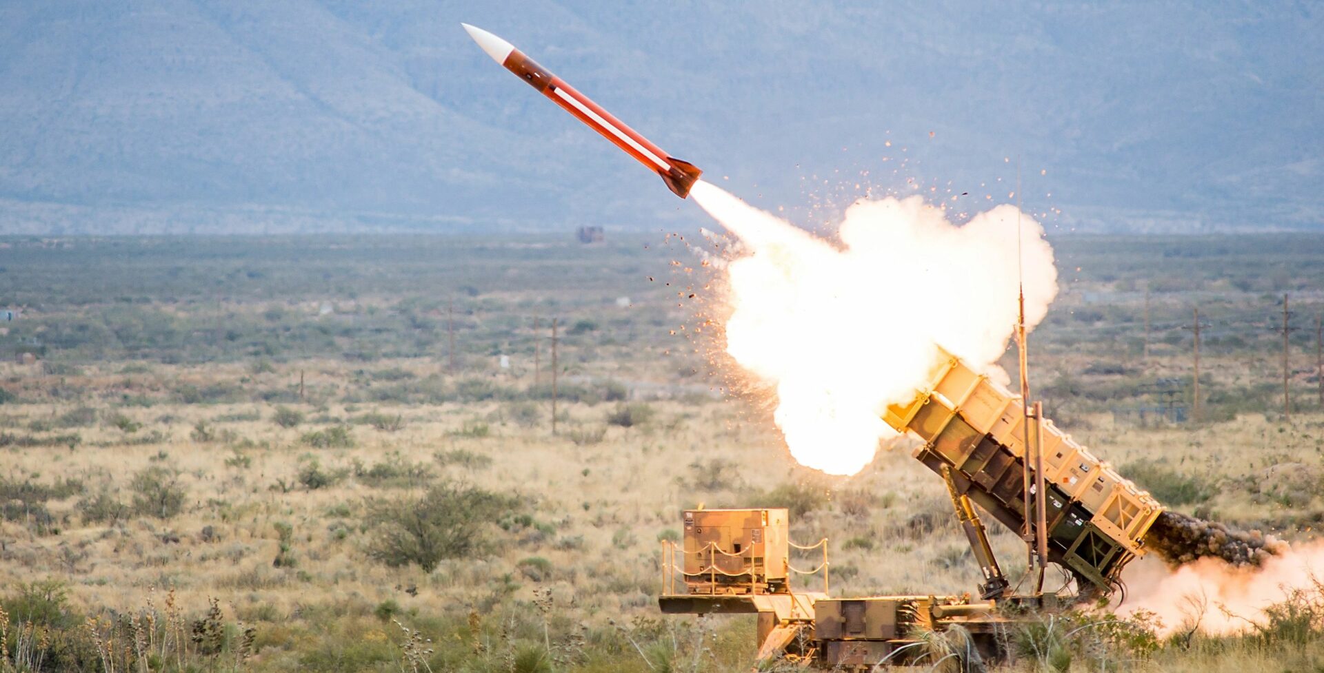 A rocket is being fired from an army vehicle.
